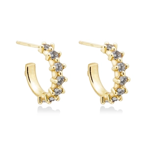 Macro detail of gold-plated silver cuff earrings showing 925 hallmark and zircon inlay