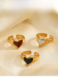 Detailed view of heart enamel open rings in red, white, and black with 18K gold finish