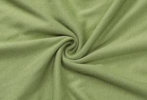 Close-up of green soft knit fabric texture with elegant folds and drapery detail