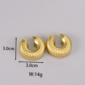 Detailed view of golden croissant hoop earrings with a textured ribbed surface