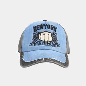 Detail of embroidered New York logo and distressed brim on washed cotton baseball cap