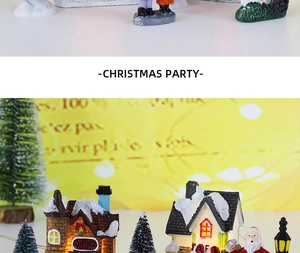 Miniature resin Christmas village set with glowing LED toy shop and snow-covered trees