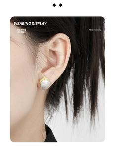 Macro detail of irregular S925 silver stud earrings with unique rock texture on model