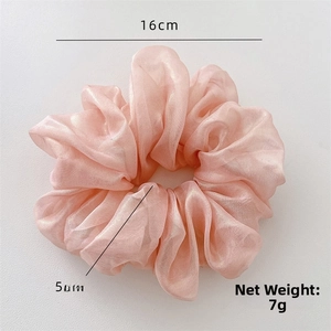 Detail view of pink iridescent silk scrunchie with 16cm diameter and 7g net weight