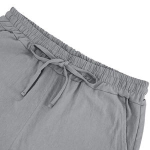 Close-up of gray linen shorts featuring an elastic drawstring waistband and breathable texture