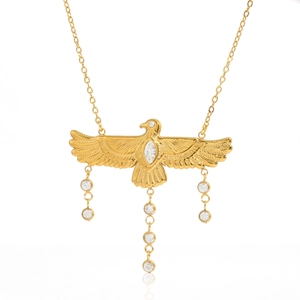 Detailed macro shot of an 18K gold-plated eagle necklace with zirconia wings and tassels