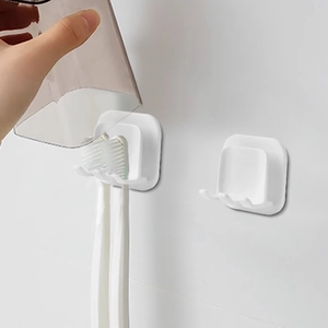 Wall-mounted white Japanese style toothbrush holder and mouthwash cup rack in bathroom