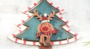 Close-up of Nordic vintage wooden Christmas tree ornament with painted reindeer design