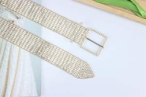 Macro detail of luxury golden wide waist chain with ten rows of sparkling crystal rhinestones