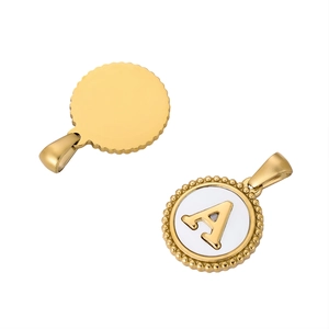 Golden round pendant with letter A engraving and scalloped edges on white background
