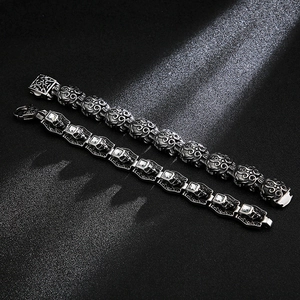 Vintage gothic skull bracelets in antique silver finish with ornate patterns on black background