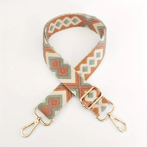 Close-up of diamond jacquard fabric strap with gold metal hooks for handbags
