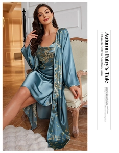 Detail of silk satin pajama set with floral print featuring a long sleeve robe and slip dress