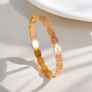 Elegant 18K gold plated titanium steel bangle with classic quilted pattern design