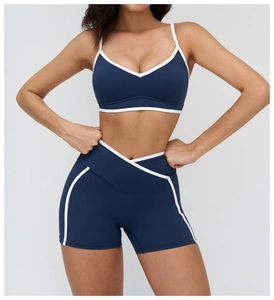 Detail of navy yoga set with white piping and high-waisted crossover shorts