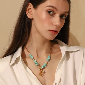 18K gold-plated stainless steel coral heart necklace with turquoise and pearls worn by a model