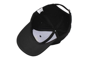 Interior detail of black cotton baseball cap showing 6-panel structure and adjustable strap