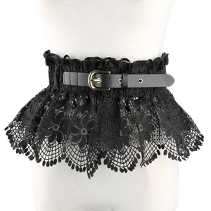 Detail of wide black lace corset belt with floral patterns and gold buckle leather strap