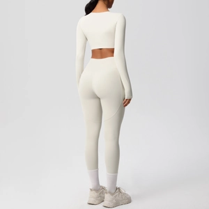 Rear view detail of cream yoga set with cropped long sleeve top and high waist leggings
