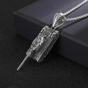 Macro detail of a 3D silver tank pendant on a black textured background