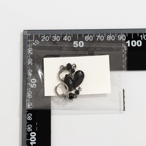 Detail view of gothic black faceted teardrop earrings with measurement scale