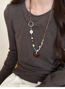 Ethnic beaded necklace featuring a glossy red heart pendant and vintage mixed stones