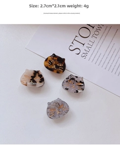 Detail view of mini 2.7cm cat-shaped hair claws in four marble patterns and colors