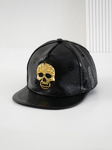 Detailed view of black crocodile pattern leather baseball cap with gold crystal skull