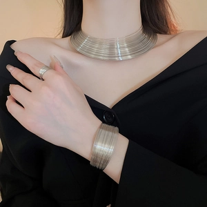 Close-up of silver multilayer chunky choker, cuff bracelet and ring set for women