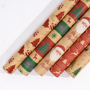Detail of kraft Christmas wrapping paper rolls with festive tree and reindeer patterns