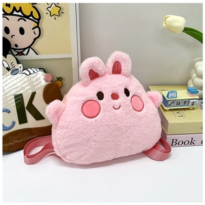 Close-up of pink plush bunny backpack with embroidered facial features and soft straps
