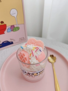 Close-up of strawberry chocolate dessert candle with pink waffle and cream decorations