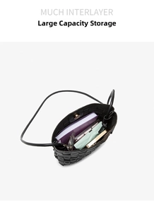 Internal view of a black woven bucket bag showing large storage capacity and items