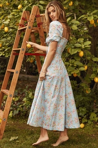Detail of light blue floral dress with puff sleeves and sweetheart neckline in orchard