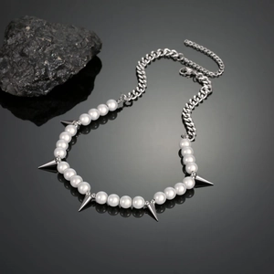 Hip hop titanium steel necklace featuring white pearls and metallic spikes on black background
