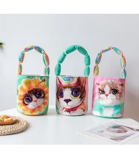Detailed close-up of colorful cartoon cat printed canvas bucket bags with padded handles