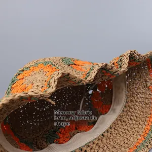Detail of straw hat featuring hand-woven flowers and shapeable memory wire brim