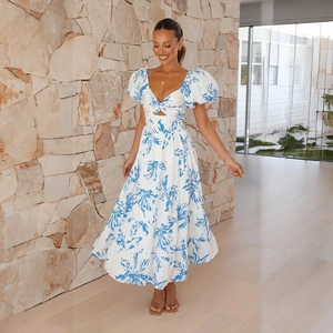 Detail of puff sleeves and waist cutout on a white and blue floral summer maxi dress