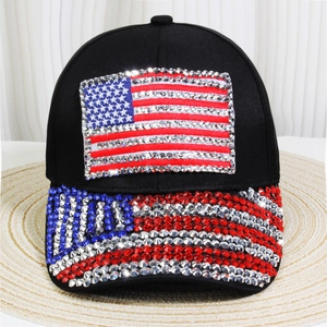 Detailed view of the American flag pattern made of rhinestones on the black denim cap