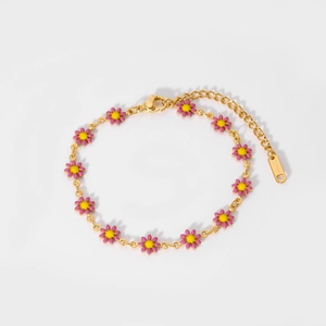 Macro shot of 18K gold plated stainless steel bracelet with pink and yellow daisies