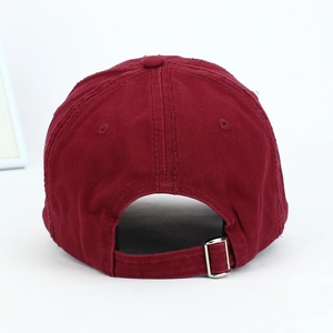 Detail view of burgundy cotton baseball cap featuring adjustable silver metal buckle at the back