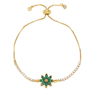 Detail of adjustable gold bracelet with green gemstone flower and white zircon accents