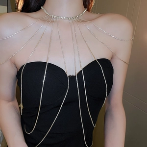 Detailed view of silver bridal body chain with rhinestones on shoulder worn by model