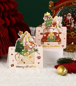 Detail of gold foil Merry Christmas cards with Santa Claus and envelope motifs