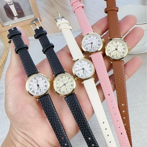 Classic Roman numeral quartz watch set with gold case and assorted leather straps