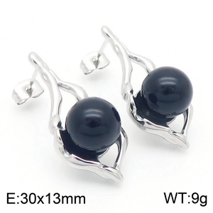 Detailed view of silver irregular geometric earrings with a black pearl accent