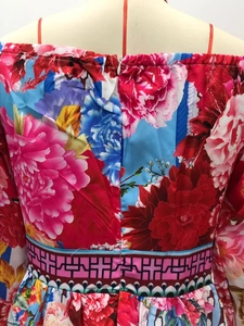 Detail of floral evening dress featuring hidden back zipper and decorative waist pattern