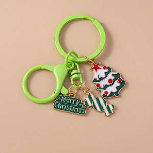 Detailed view of Christmas keychain with green tree, candy charm, and Merry Christmas tag
