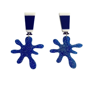 Blue glitter acrylic earrings with geometric blue striped top on white background