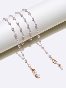 Detail of lavender rice pearl eyewear chain with golden lobster clasp and silicone loops